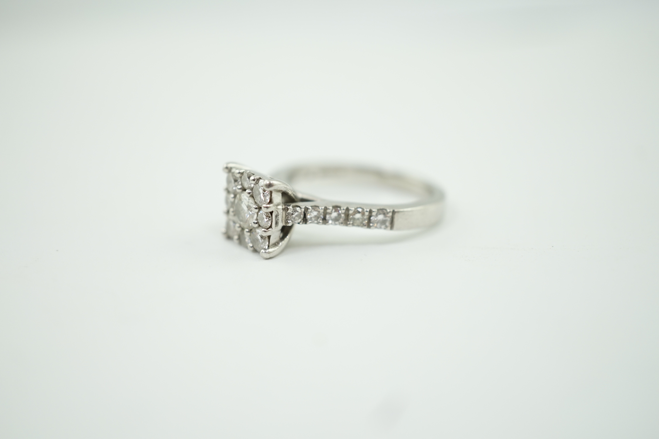 A modern platinum and nine stone diamond set square cluster ring